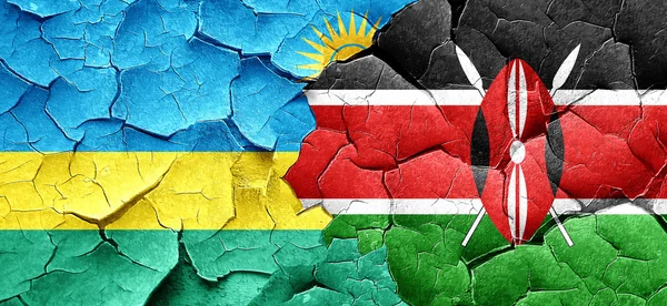 Rwanda flag with Kenya flag on a grunge cracked wall