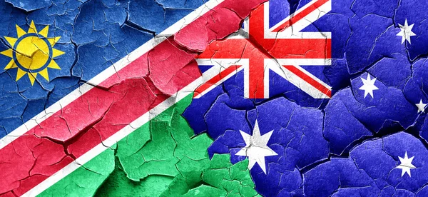 Vlajka Namibie s příznakem Austrálie na grunge popraskané zdi — Stock fotografie