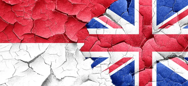 Monaco flag with Great Britain flag on a grunge cracked wall — Stock Photo, Image