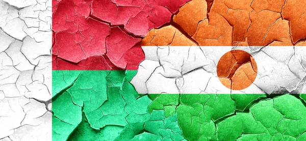 Madagascar flag with Niger flag on a grunge cracked wall — Stock Photo, Image