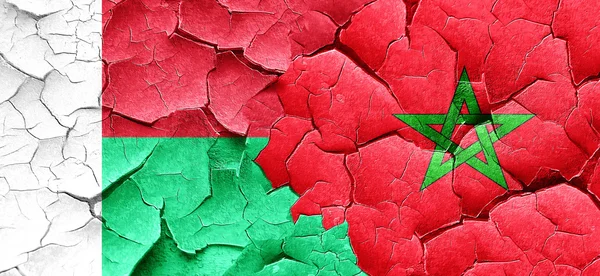 Madagascar flag with Morocco flag on a grunge cracked wall — Stock Photo, Image