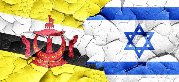 Brunei flag with Israel flag on a grunge cracked wall