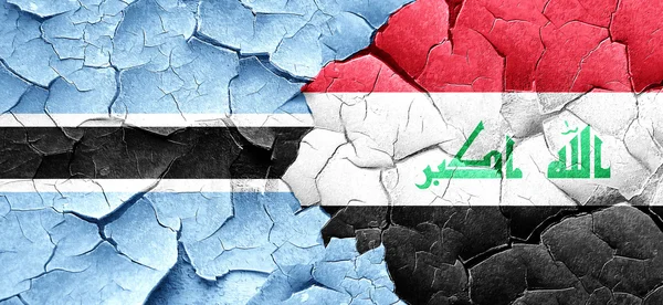 Botswana flag with Iraq flag on a grunge cracked wall