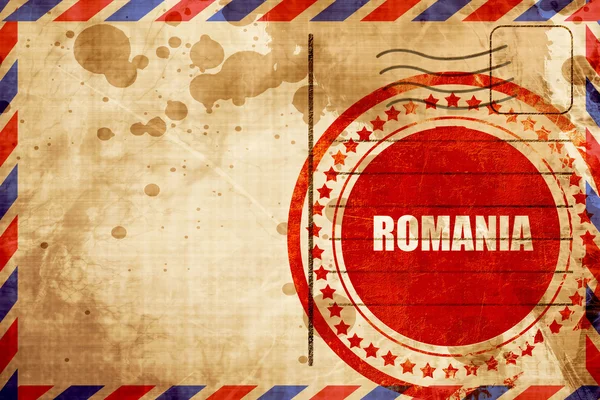 Salutations de Roumanie, timbre grunge rouge sur un backgroun de poste aérienne — Photo
