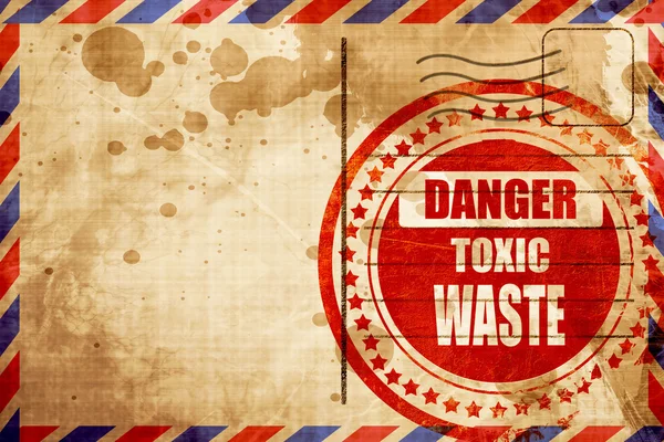 Toxic waste sign, red grunge stamp on an airmail background — Stock Photo, Image