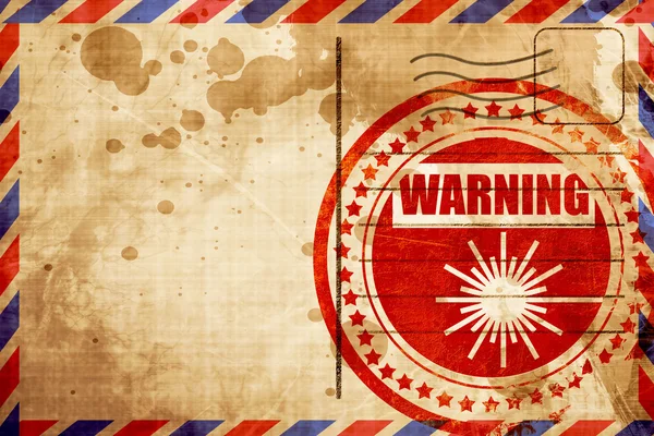 Лазерный предупреждающий знак, красная марка гранжа на фоне авиапочты — стоковое фото