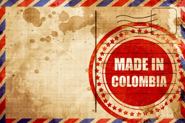Hecho en Colombia, sello grunge rojo en un fondo de correo aéreo — Foto de Stock