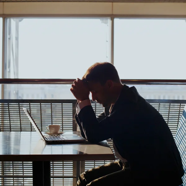 Depressed businessman with laptop — Stock Photo, Image