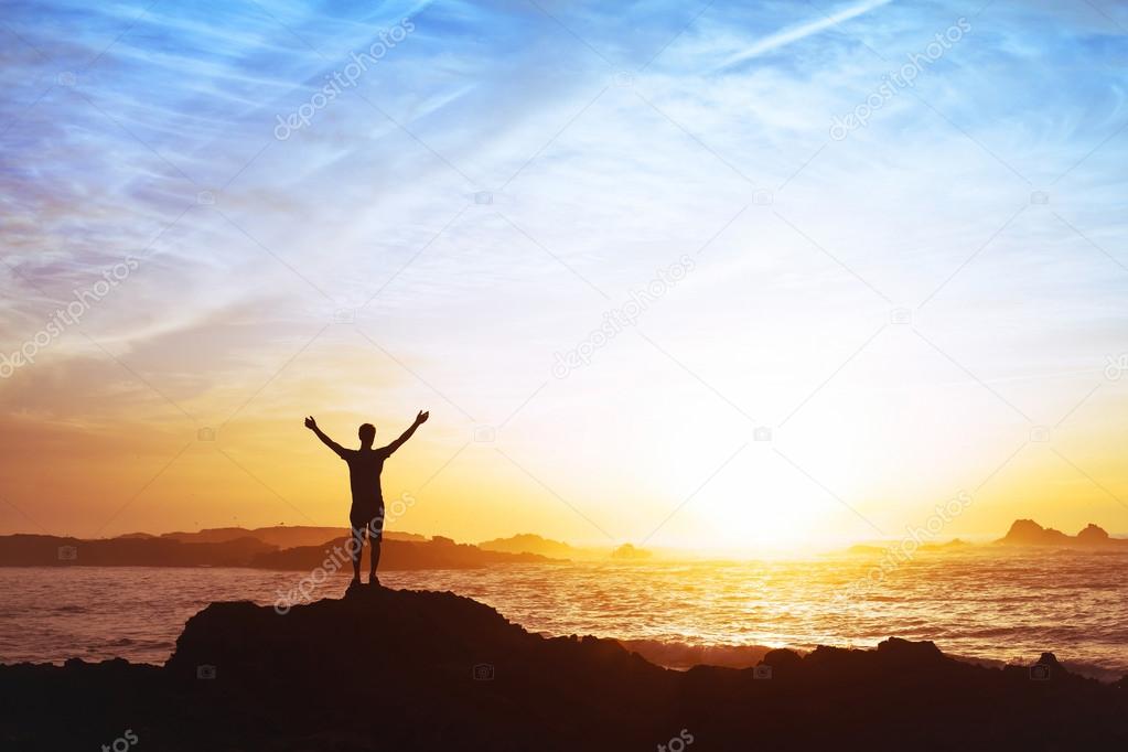 Man  on rock at sunset