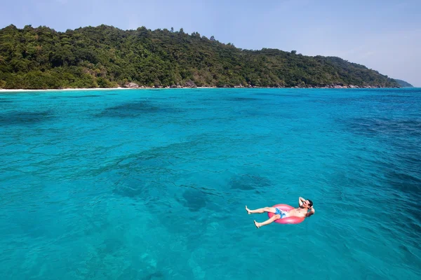 man swimming in lifebuoy