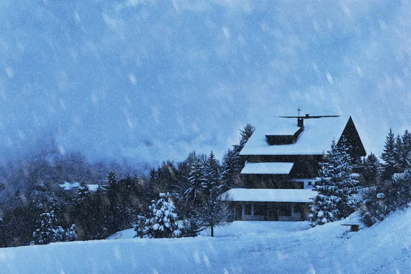 Snowfall and wooden house — Stock Photo, Image