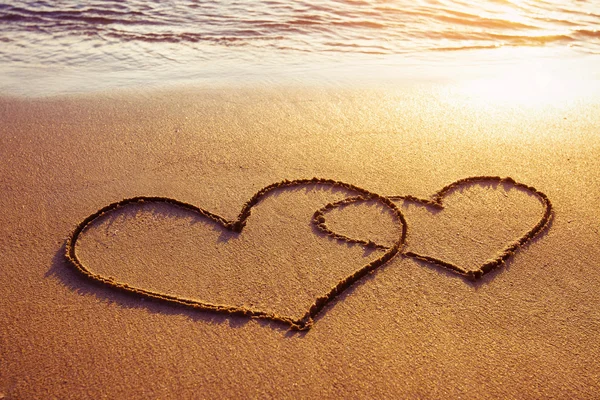 Hearts drawn on the beach Stock Image