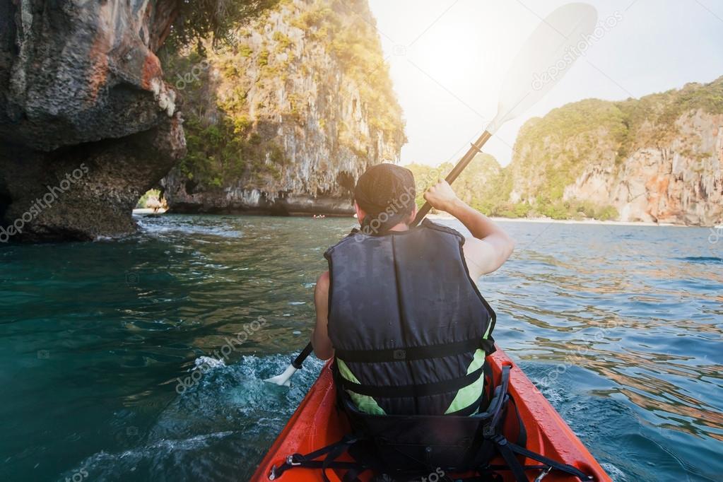 man in life jacket kayaking