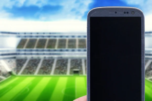 Smartphone na stadionie — Zdjęcie stockowe