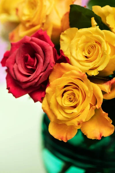 Bouquet of yellow and pink roses in vase