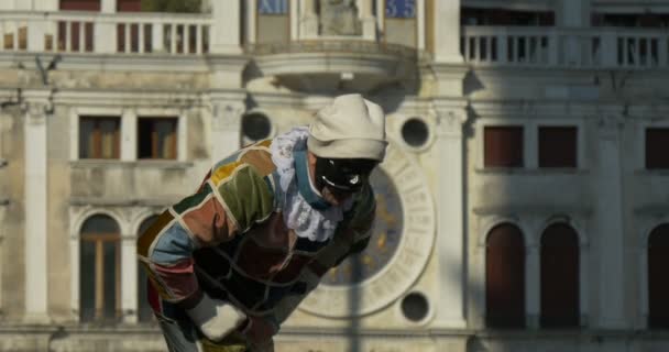 Человек, одетый как арлекин, типичная венецианская маска, во время Венецианского карнавала 16 февраля 2015 года в Венеции, Италия — стоковое видео