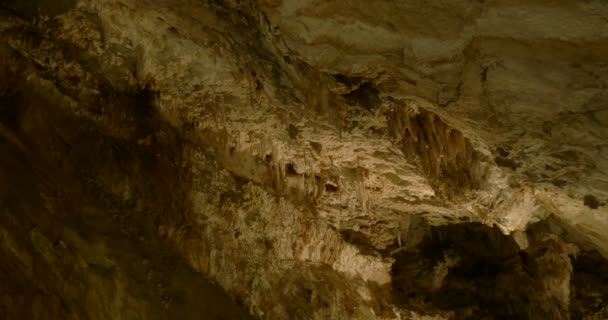 Rocas calizas, estalactitas y estalagmitas en una cueva — Vídeo de stock