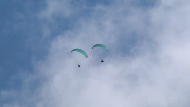 Två paragliders på himlen, under Acroaria (legendariska akrobatiska skärmflygning VM) — Stockvideo