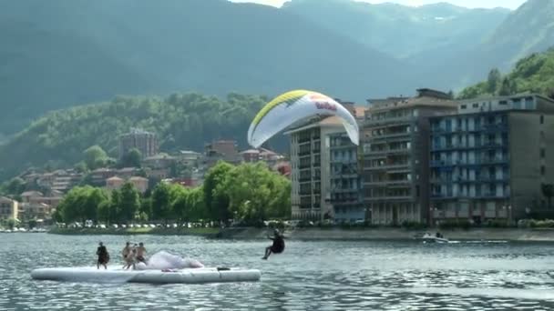 Paragliders spiraling over lake (in slow motion) during AcroAria, the legendary acrobatic paragliding world cup — Stock Video