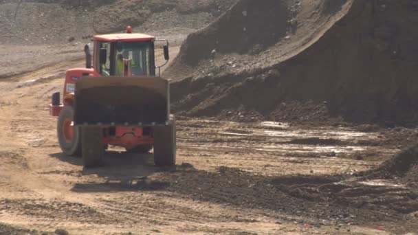 Bulldozer unloading soil and stone at construction site — Stock Video
