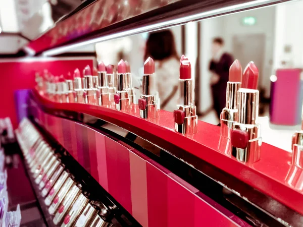 lipsticks on stand in makeup store, close up shot
