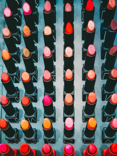 lipsticks on stand in makeup store, close up shot