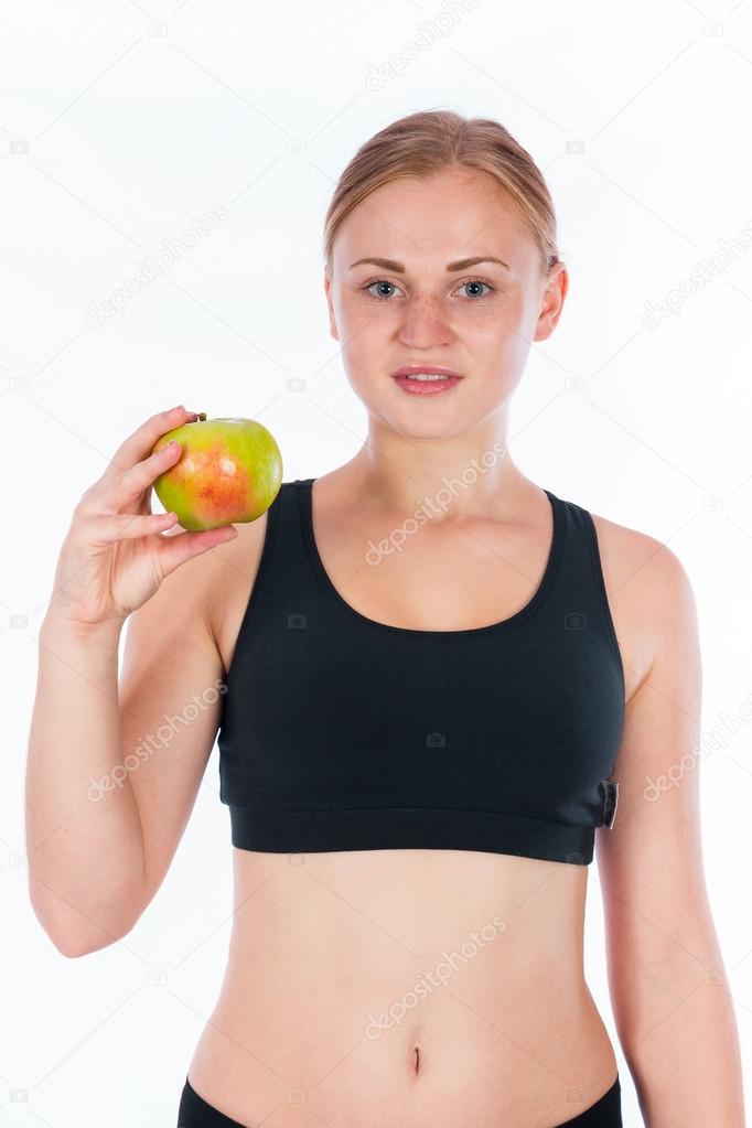 Beautiful young blonde woman with an apple in his hand