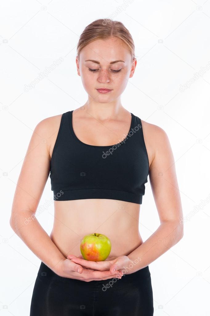 Beautiful young blonde woman with an apple in his hand