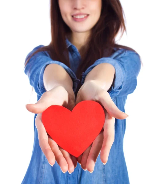 Love and Valentine's Day beautiful brunette holding a red heart in hands isolated on white background — Stock Photo, Image