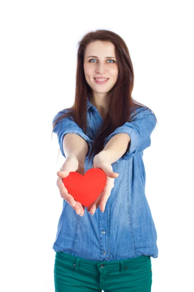 Love and Valentine's Day beautiful brunette holding a red heart in hands isolated on white background — Stock Photo, Image