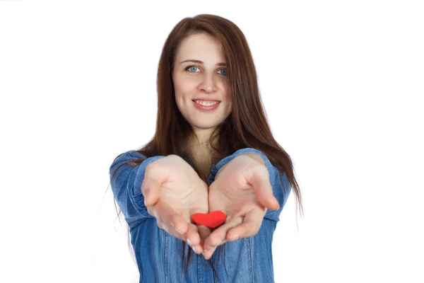 Love and Valentine's Day beautiful brunette holding a red heart in hands isolated on white background — Stock Photo, Image