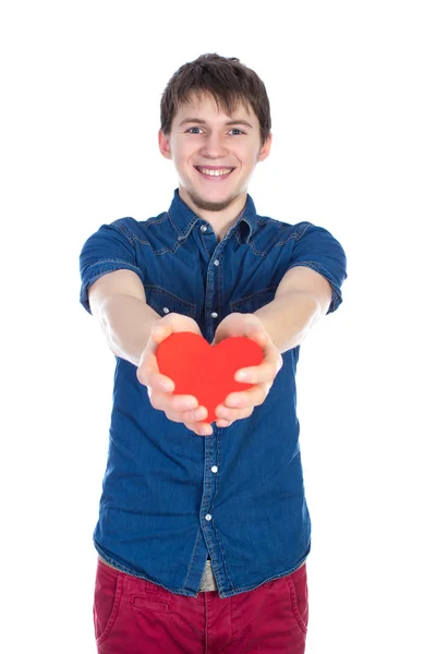 Handsome brunette mans holding a red heart, isolated on white background Royalty Free Stock Images
