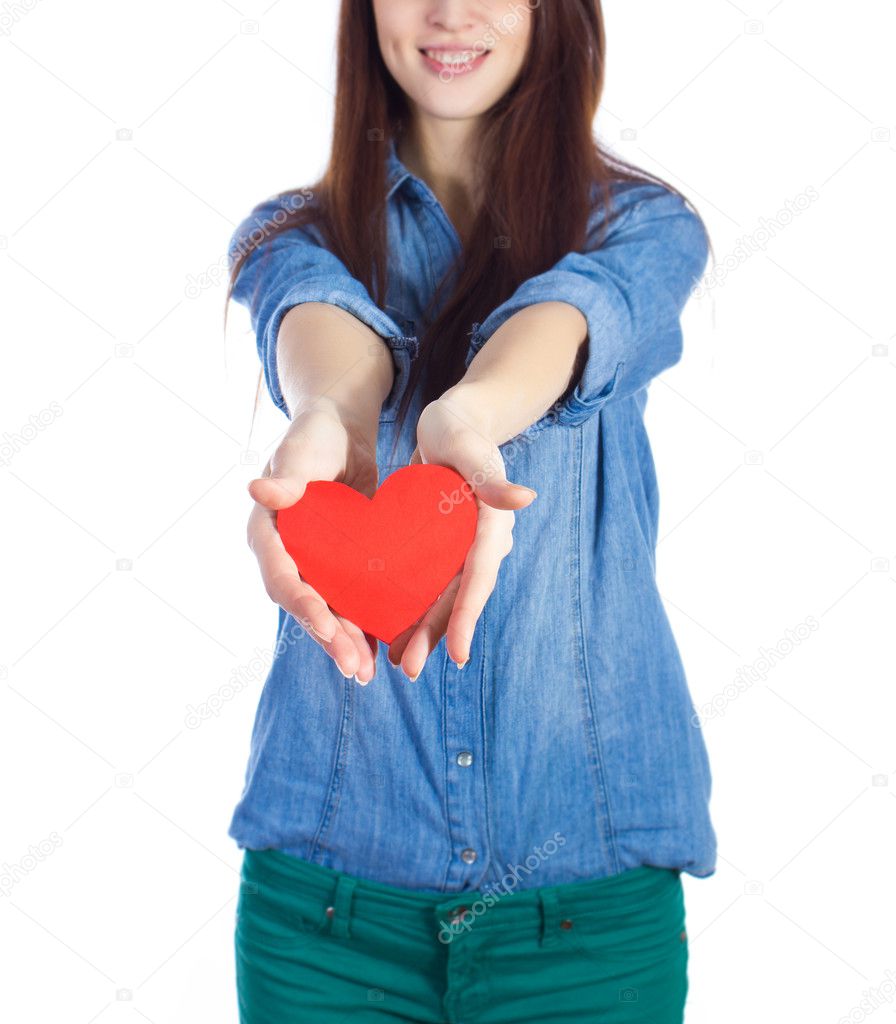 Love and Valentine's Day beautiful brunette holding a red heart in hands isolated on white background