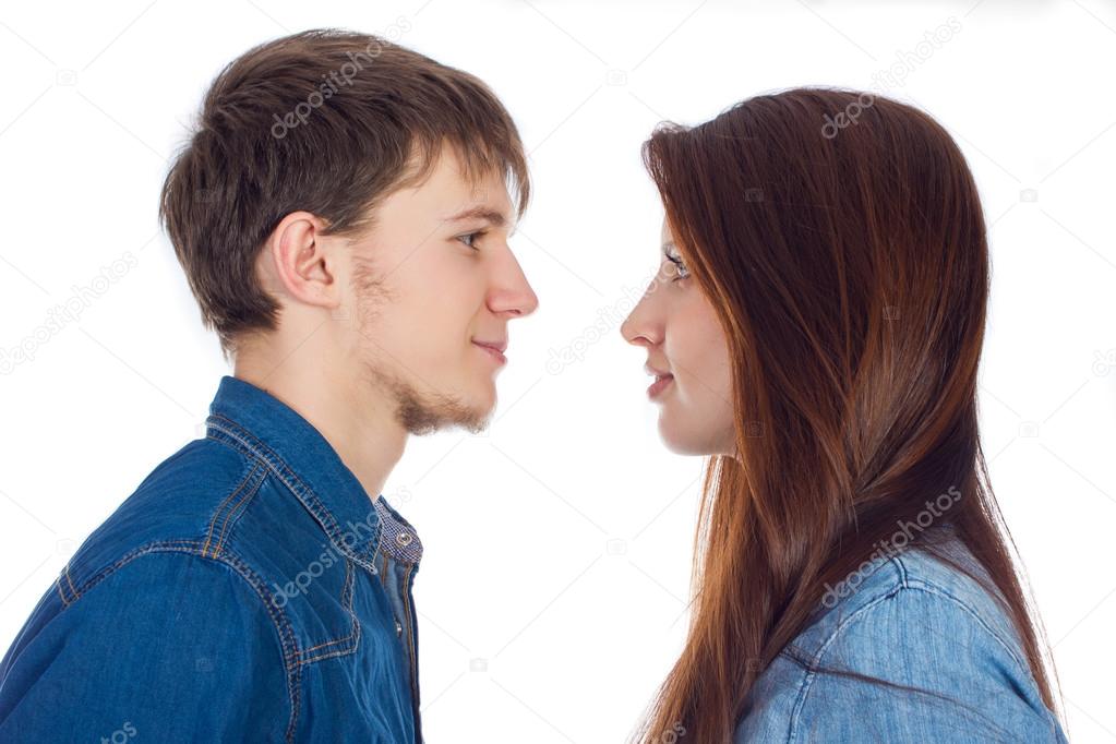 Beautiful and young loving couple, standing opposite each other