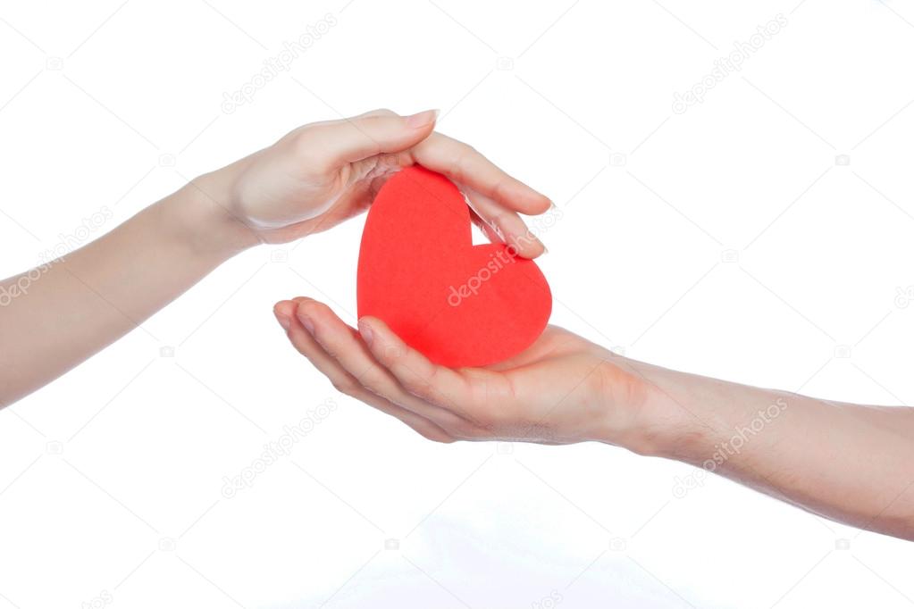 Couple in love holding a red paper heart in their hands isolated on white Background