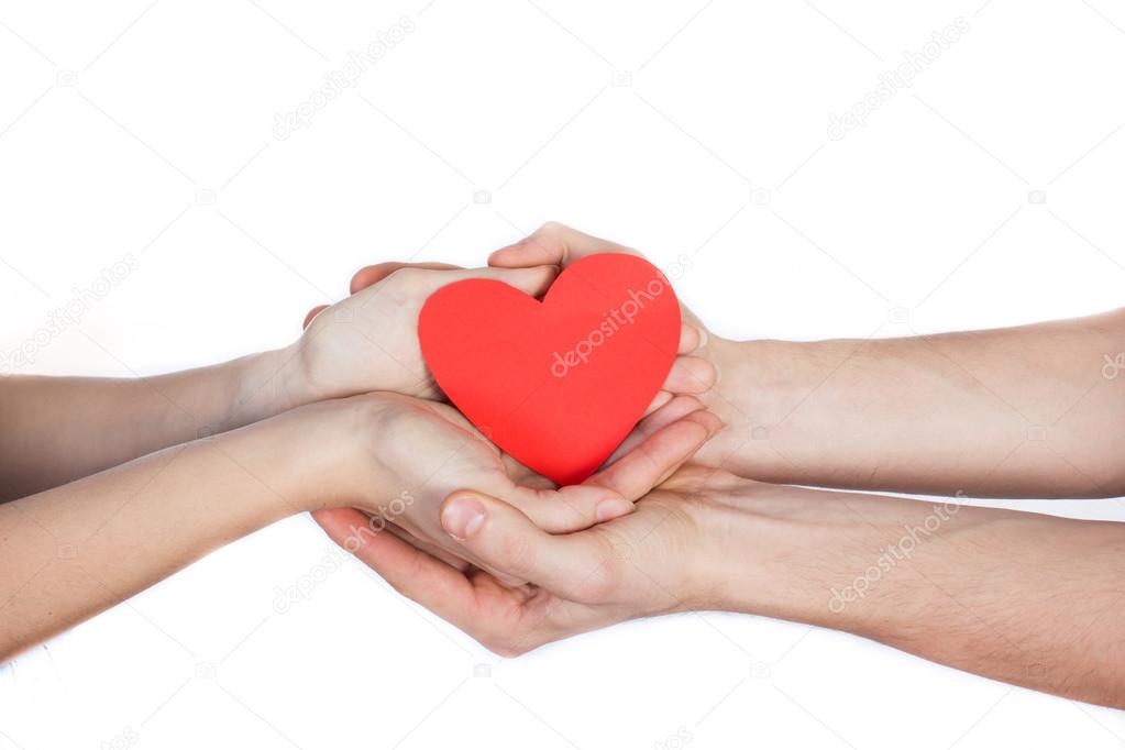 Couple in love holding a red paper heart in their hands isolated on white Background
