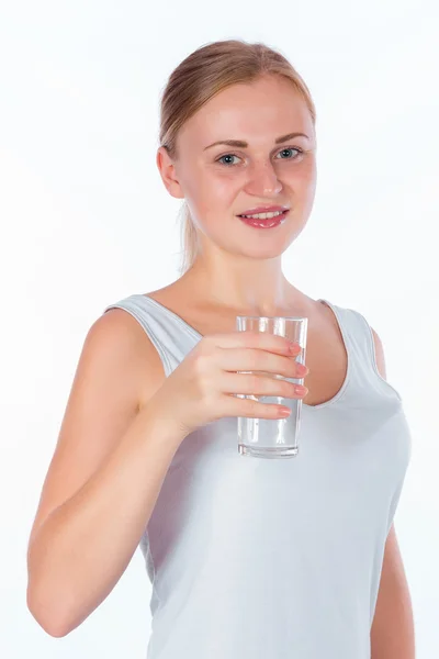 Young happy girl holding a glass of water — Stock fotografie