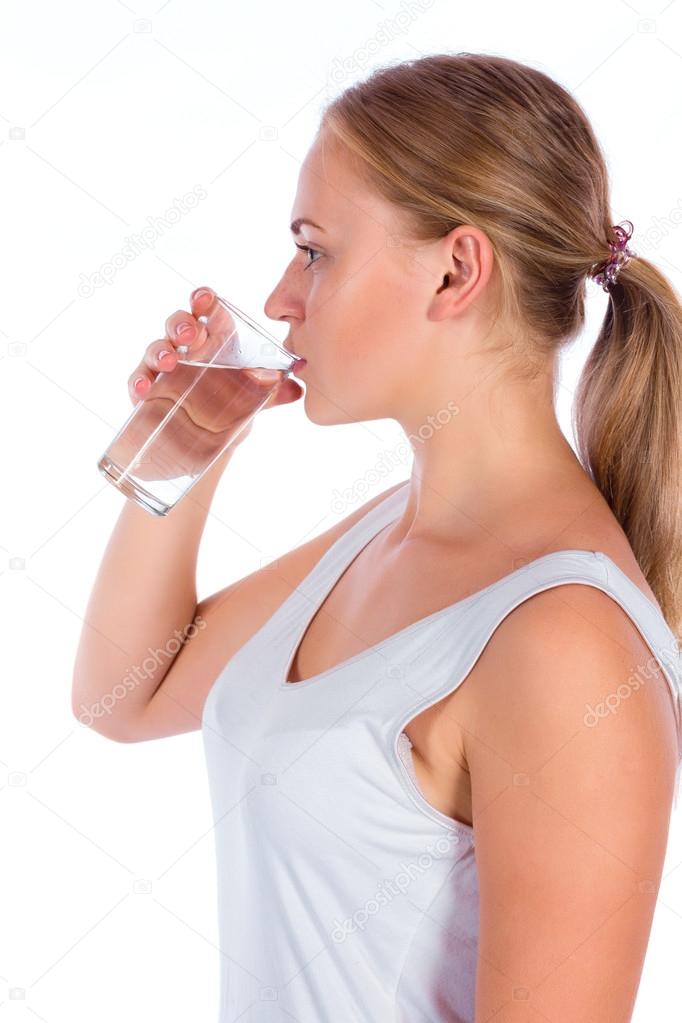 young happy girl drinking water from glass