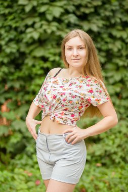 Yaz aylarında poz doğa güzel sarışın kız üzerinde uzun kahverengi saçlı güzel bir genç kadının portresi