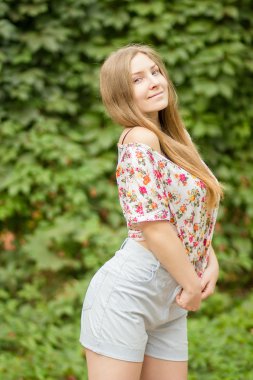 Yaz aylarında poz doğa güzel sarışın kız üzerinde uzun kahverengi saçlı güzel bir genç kadının portresi