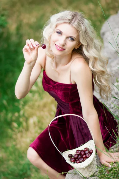 Woman with berries in basket — Stock Photo, Image