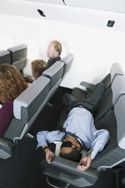 Businessman sleeping on airplane