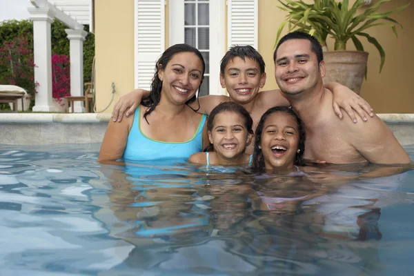 Multi-ethnic family in swimming pool