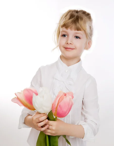 Cute little girl with the tulips — Stock Photo, Image