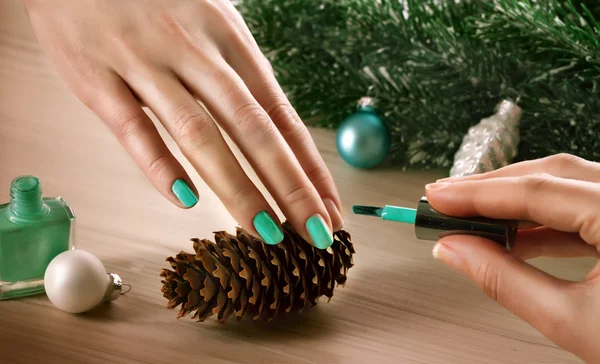 Woman applying nail varnish to finger nails — Stock Photo, Image