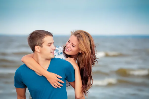 Couple of a young lovers on the beach having dating — Stock Photo, Image