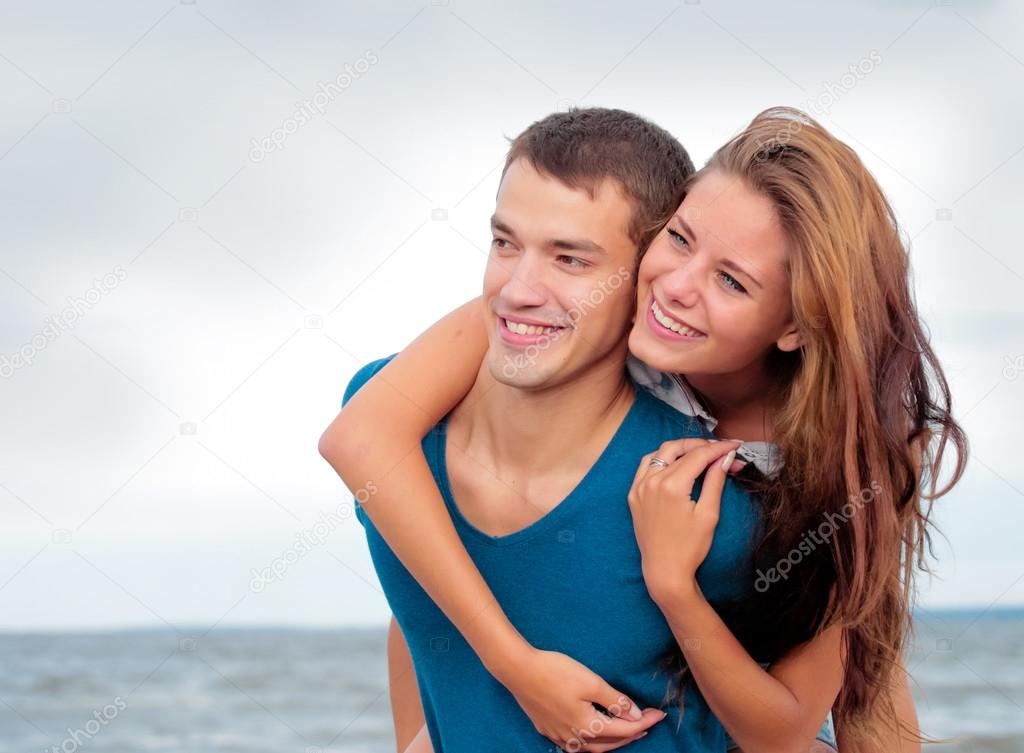 Couple of a young lovers on the beach having dating