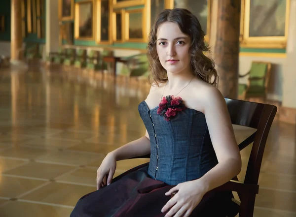 Beautiful woman wearing corset posing in  palace — Stock Photo, Image