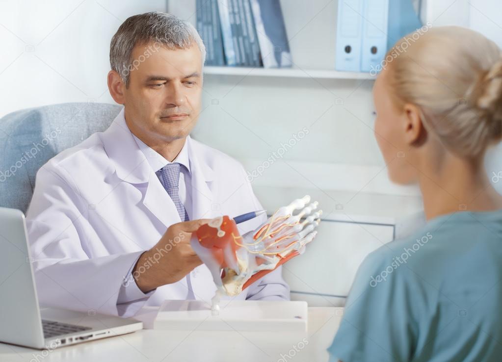 Orthopedic doctor in his office with the model of the feet Stock Photo