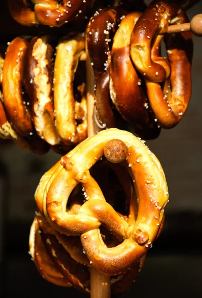 Pretzels hanging on stand at Christmas food market — Stock Photo, Image